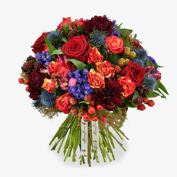 Thistles, rubus and scarlett berries are entwined to create this romantic and extravagant bouquet.